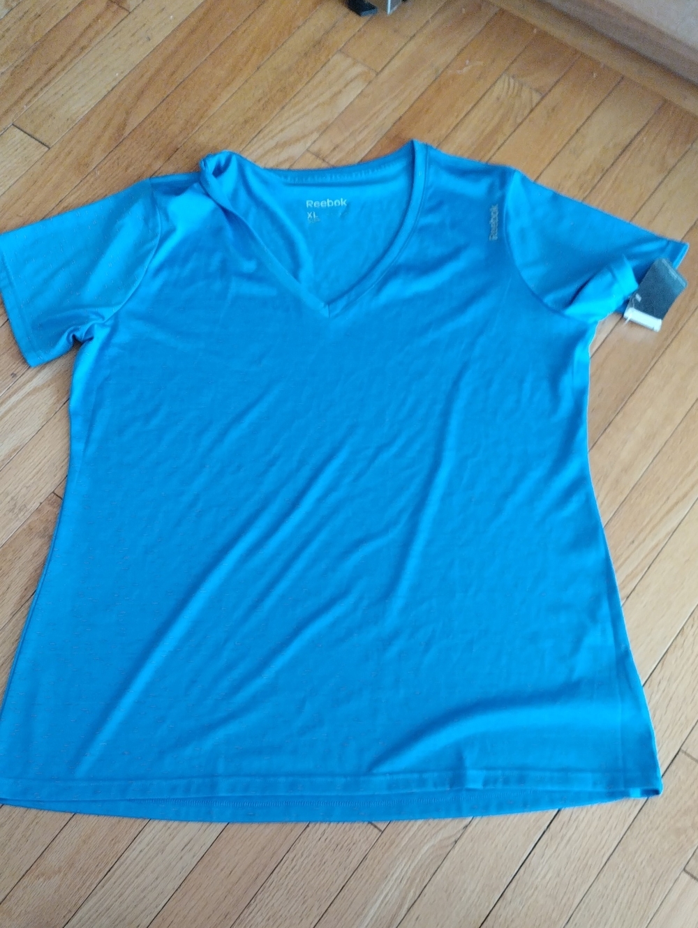 Reebok Women's V-Neck Short Sleeve Tee in Bright Blue